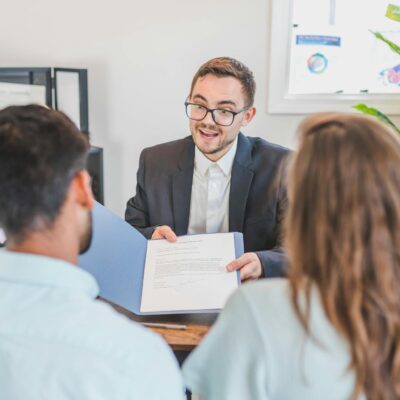 A Broker Showing a Couple the Mortgage Contract