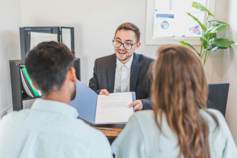 A Broker Showing a Couple the Mortgage Contract