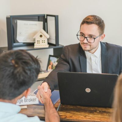 A Mortgage Broker Handshaking with Clients