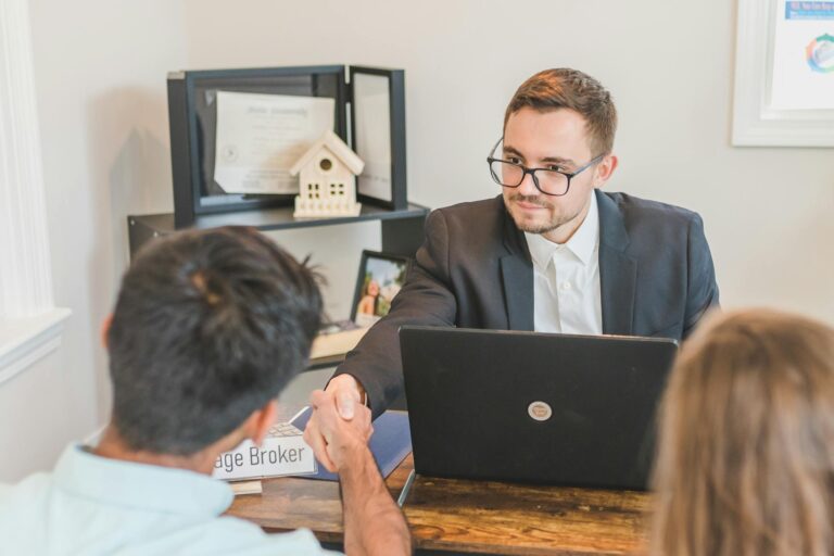 A Mortgage Broker Handshaking with Clients